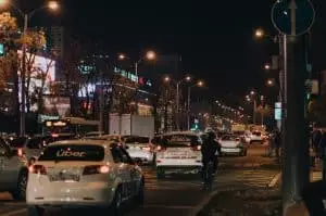 Busy nighttime scene of urban life and traffic in Krasnodar, Russia city center.