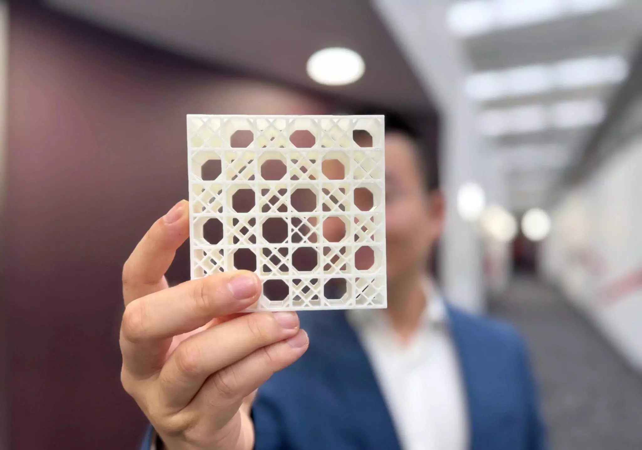 Le Dr Jiaming Ma tient un modèle imprimé en 3D de la conception en double treillis de l'équipe