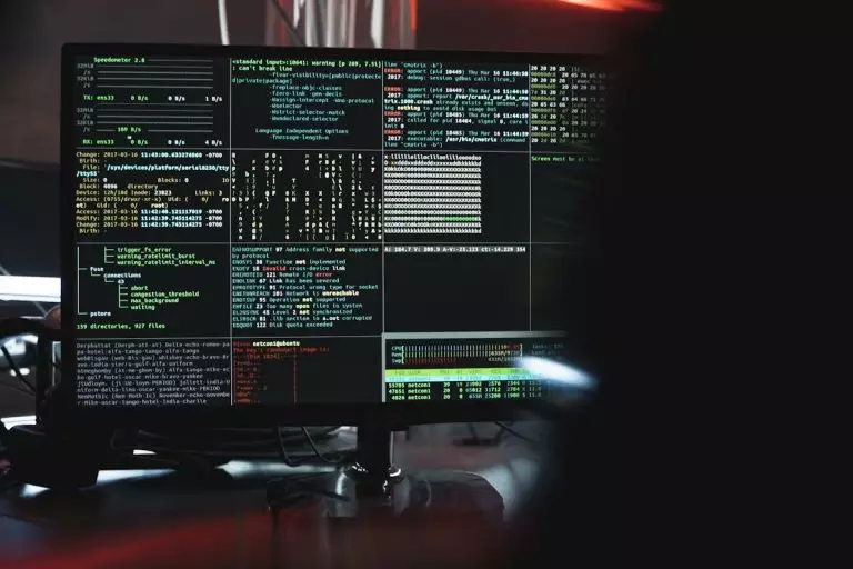 Tendances de cybersécurité : que peuvent faire les entreprises pour rester en sécurité en ligne ? Close-up of a computer monitor displaying cyber security data and code, indicative of system hacking or programming.