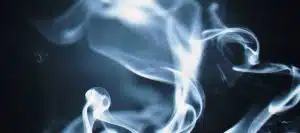 Artistic close-up of swirling white smoke against a dark background, creating a mystical effect.